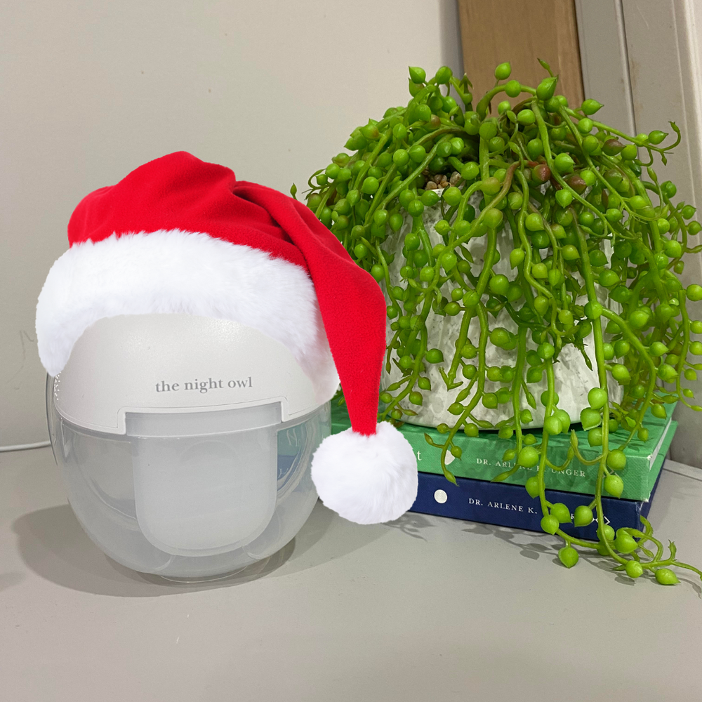 Holiday breastfeeding survival guide with Night Owl wearable breast pump and festive Christmas decorations