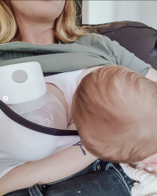 Mum cuddling newborn while pumping